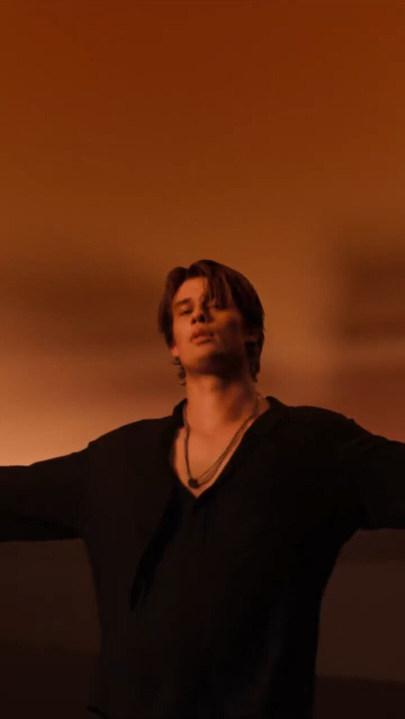 Nicholas Galitzine stars in an Emporio Armani "Stronger With You" fragrance campaign, featuring him dancing and highlighting the perfume bottles, "EMPORIO ARMANI STRONGER WITH YOU Powerfully" and "Intensely."