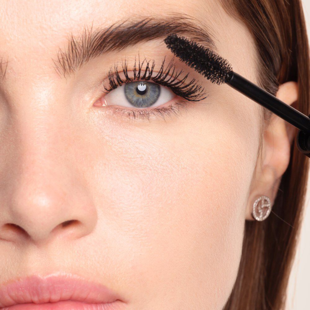 Applying Armani Beauty Vertigo Drama mascara to lift and define the lashes