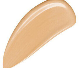 A smooth, creamy swatch of beige foundation makeup on a white background.