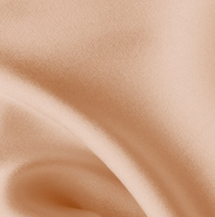Close-up of soft, textured fabric in a warm peach color.