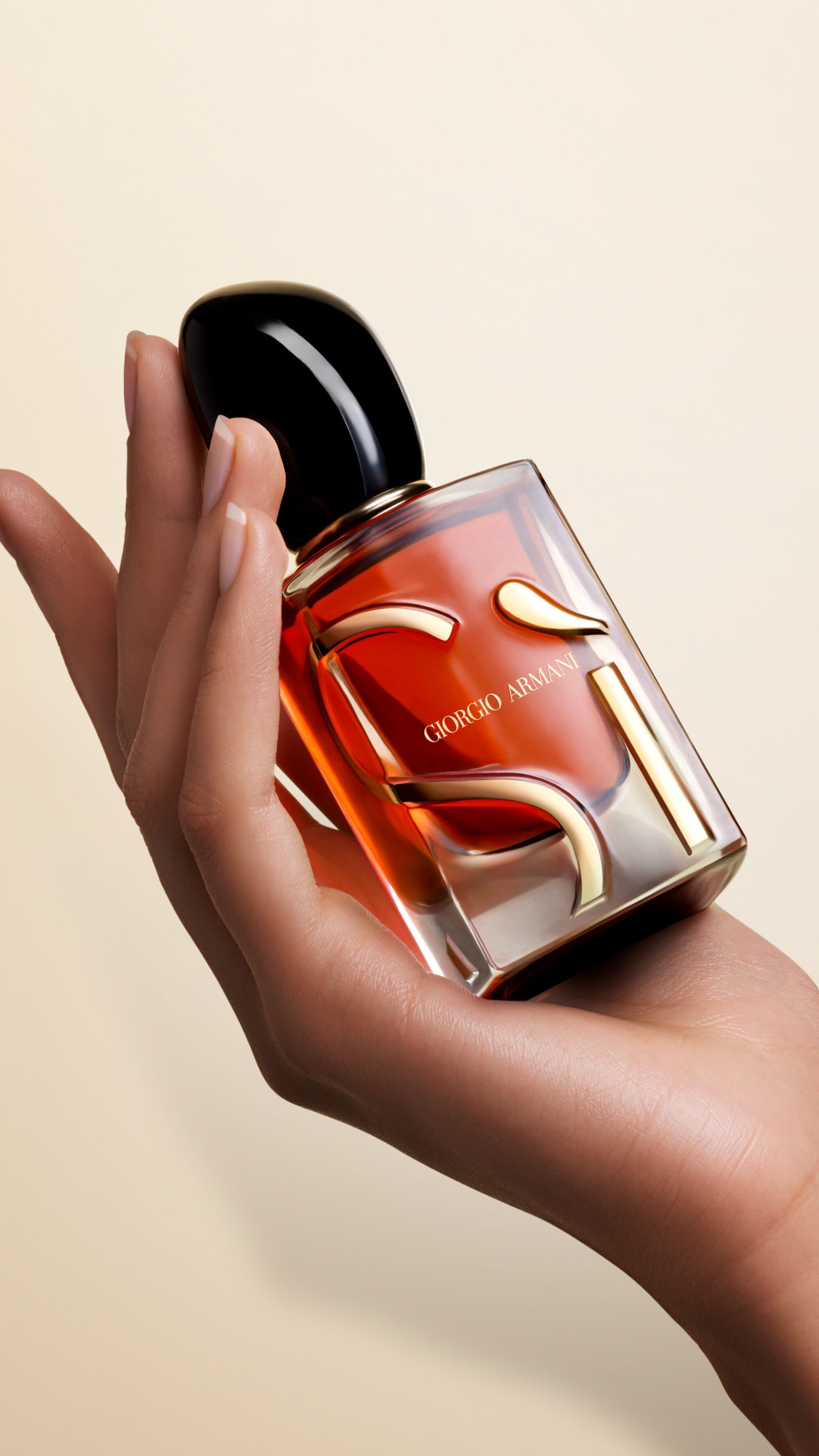 Une main tenant un flacon de SI PARFUM