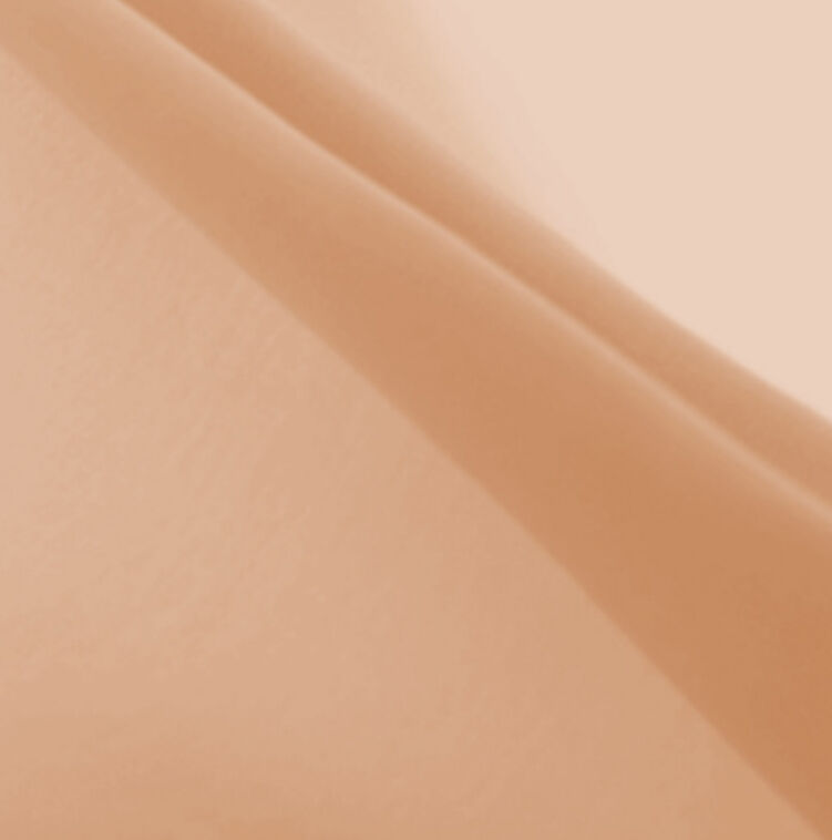 A close-up of smooth, wrinkled fabric in a warm beige tone, creating a soft, textured background.