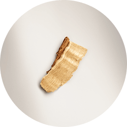 A single, elegant slice of green pear, is presented on a white background.