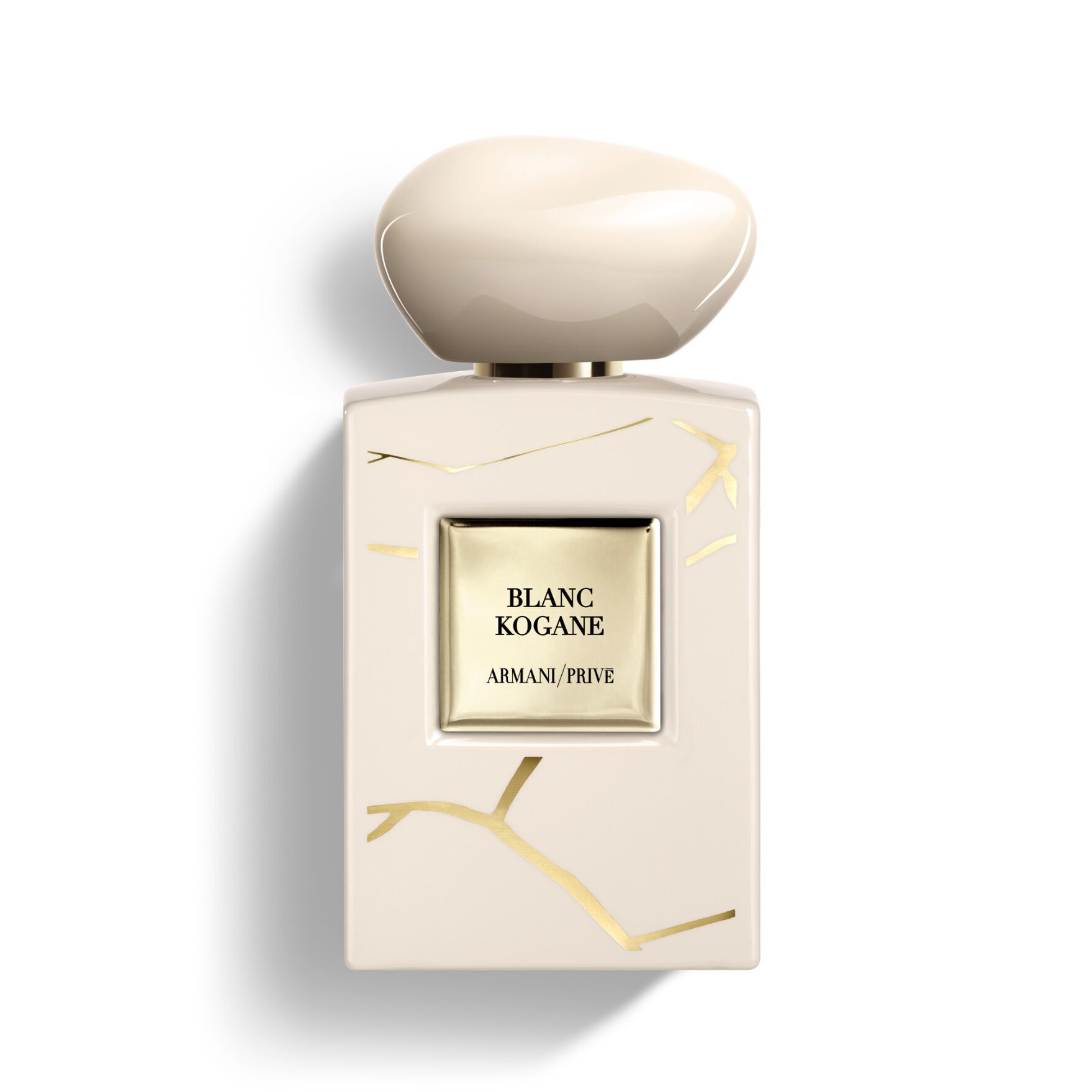 Armani/Prive Blanc Kogane: luminous bottle set within a round vessel with gold-veined accents, symbolizing sophisticated artistry.
